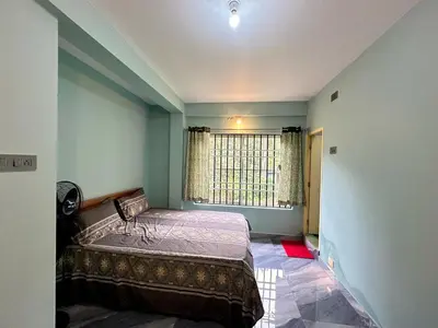 a bedroom with a bed and a window at Leaf links Coorg in Siddapur
