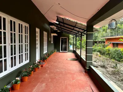 a hallway of a building with potted plants on it at Leaf links Coorg in Siddapur