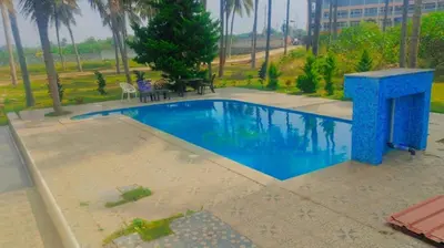 a swimming pool in a yard with a table and chairs at Blue Moon Homestay in Mysore