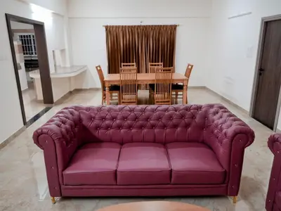 a living room with a purple couch and a table at Amaira Studio living - Coimbatore in Coimbatore