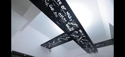 a black bow tie with white writing on it at AZURE stay happy in Pudunagaram