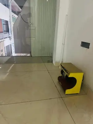 a guitar sitting on the floor in a room at AZURE stay happy in Pudunagaram