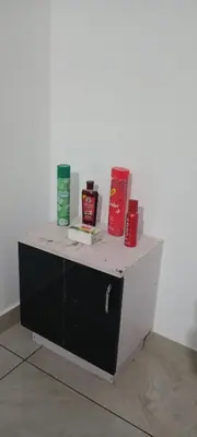 a small cabinet with some items on top of it at Green palace service villa in Kalpetta