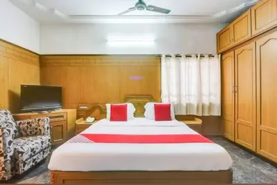a hotel room with a bed and a tv at The vivekam Homestay nr Hindustan college Nava india in Singānallūr