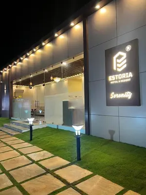 a building with a sign on the side of it at Estoria Hotel and Resort in Kadakola