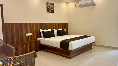 a bedroom with a large bed in a room at Estoria Hotel and Resort in Kadakola