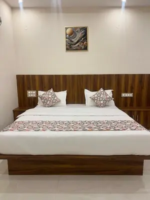 a large bed in a room with at Estoria Hotel and Resort in Kadakola