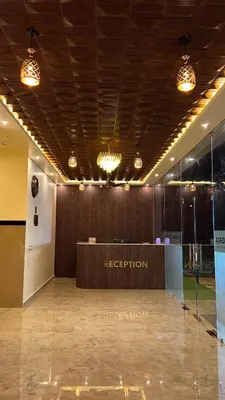 a lobby with a reception desk in a building at Estoria Hotel and Resort in Kadakola