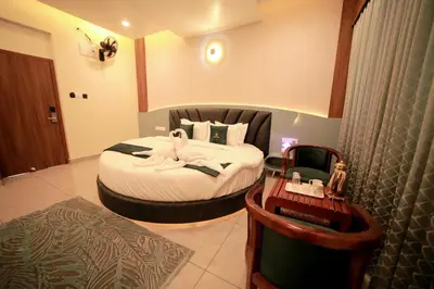 a hotel room with a bed in a room at LUMARISE Premium Wayanad Business Hotel in Sultan Bathery