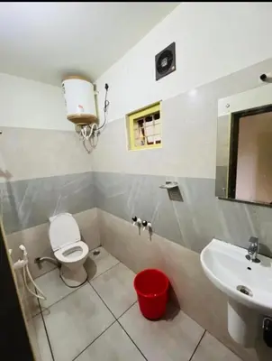 a bathroom with a toilet and a sink at Chillwind Service villa in Padinjarathara