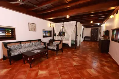 a living room with a couch and a table at SVS Arena in Kodali