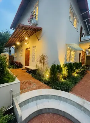 a house with a walkway in front of it at Nesara Home Stay Mysuru in Mysore