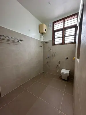 a bathroom with a toilet and a shower at Villa Vinaya- Comfort, Calm & Charm in Mysore in Mysore