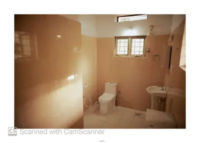 a bathroom with a toilet and a sink at Coorg River Song Homestay in Kushālnagar
