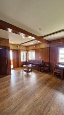 a large living room with a couch and a table at Meadows mist ooty in Ooty