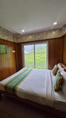 a bedroom with a large bed with a window at Meadows mist ooty in Ooty