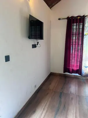 an empty room with a television on the wall at Kanthalloor puregolds in Kanthalloor