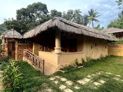 a small house with a grass roof at Earthen Pool Villa! Redefining Luxury! in Marayoor