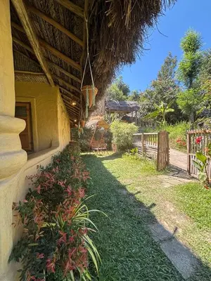 a yard next to a house with a fence at Earthen Pool Villa! Redefining Luxury! in Marayoor
