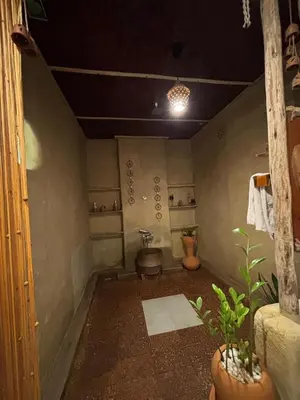 a bathroom with a toilet in the corner of a room at Earthen Pool Villa! Redefining Luxury! in Marayoor