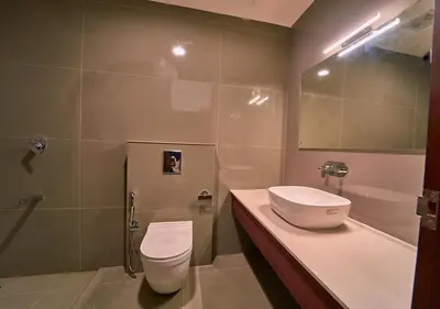 a bathroom with a sink and a toilet and a tub at Achutham Cottages Wayanad by VOYE HOMES in Padinjarathara