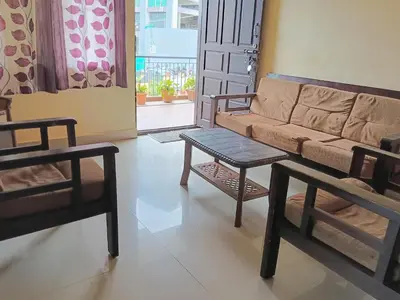 a living room with a couch and a table at Coorg villas & homes in Madikeri