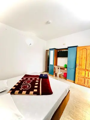 a bedroom with a bed with a blanket on it at The Haze Land in Ooty