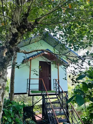 a house with a staircase leading up to a door at Nefs Dreams Villa in Vaduvanchal