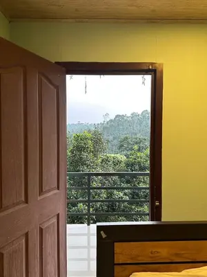 a room with a door and a view of a balcony at Nefs Dreams Villa in Vaduvanchal