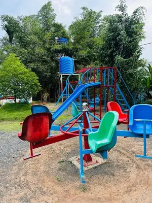 a playground with a blue and red slide at Nefs Dreams Villa in Vaduvanchal