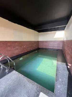 a large pool of water in a room at Kottaram Heritage in Pallipuram