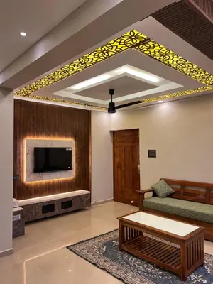 a living room with a couch and a tv at Kvm RIVER VIEW - 2bhk in Palakkad