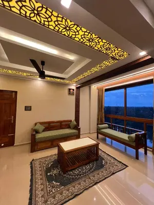 a living room with a couch and a table at Kvm RIVER VIEW - 2bhk in Palakkad