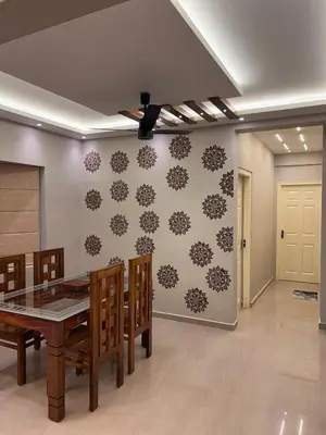 a dining room with a table and a ceiling fan at Kvm RIVER VIEW - 2bhk in Palakkad