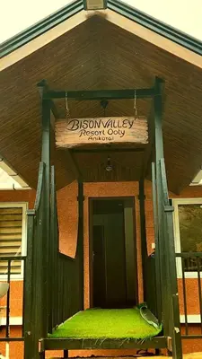 a building with a sign on the front of it at Bison valley resort Anikorai in Ooty