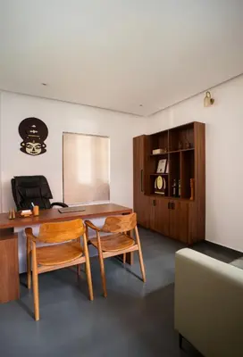 an office with a wooden desk and two chairs at Punarjeevani Ayurvedic Heritage in Vythiri