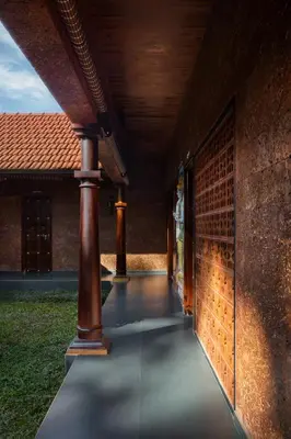 a hallway of a building with a brick wall at Punarjeevani Ayurvedic Heritage in Vythiri