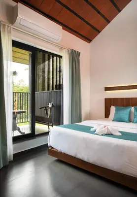 a bedroom with a bed and a large window at Punarjeevani Ayurvedic Heritage in Vythiri
