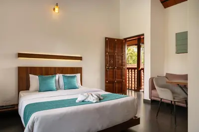 a bedroom with a bed with a dog laying on it at Punarjeevani Ayurvedic Heritage in Vythiri