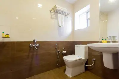 a bathroom with a toilet and a sink at FabHotel Sholas Residency I - Nr Government Rose Garden in Ooty