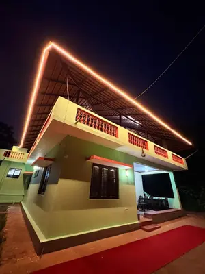 a house with lights on top of it at night at KOORGI RETREAT- Coorg in Napoklu