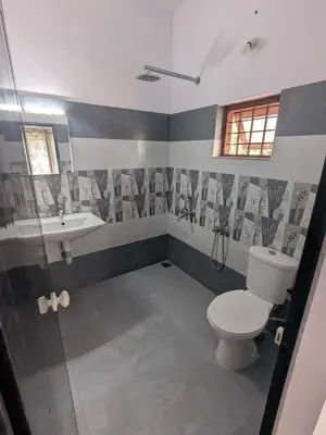 a bathroom with a toilet and a sink at Sankeerthanam - Lounge in serenity in Ernakulam