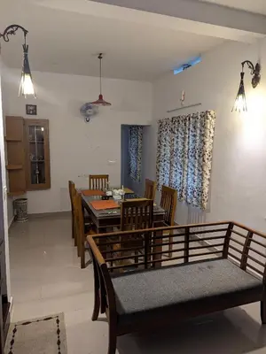 a dining room with a table and chairs at Sankeerthanam - Lounge in serenity in Ernakulam