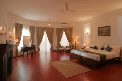 a large bedroom with a bed and a piano at The Hundred House by Kisah Stays in Ambalavayal