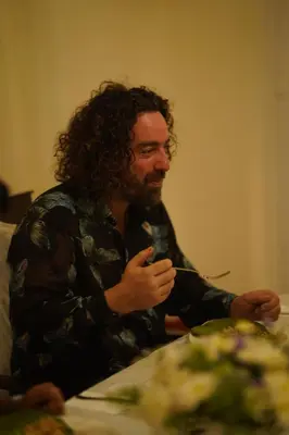 a man sitting at a table eating with a fork at The Hundred House by Kisah Stays in Ambalavayal