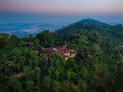 an aerial view of a house on a hill at The Hundred House by Kisah Stays in Ambalavayal