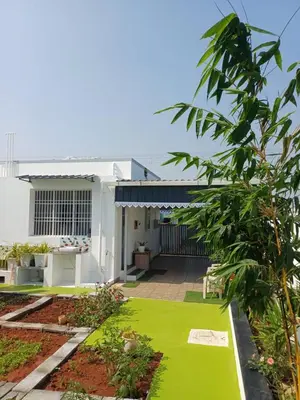 a house with a green lawn in front of it at AR Homes in Coimbatore