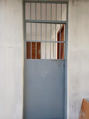 a blue door with a window in a building at AR Homes in Coimbatore