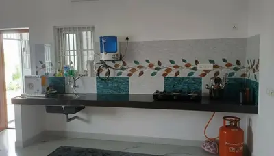 a kitchen with a counter with a counter top at AR Homes in Coimbatore
