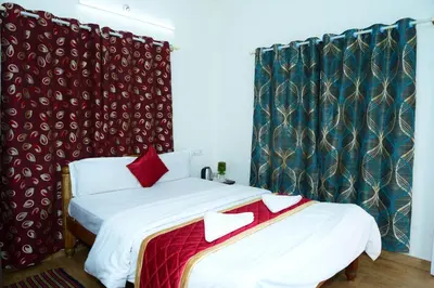 a bedroom with two beds with red and green curtains at Coorg Holiday Homes in Madikeri
